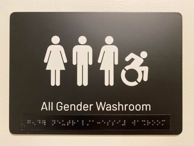 Inclusive washroom sign with braille in the Hootsuite Vancouver office