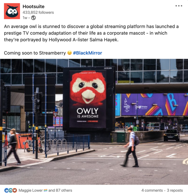 fake times square billboard of hootsuite owly mascot in style of black mirror with text reading: "owly is awesome"