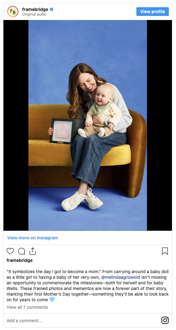Framebridge customer interview featuring mother holding baby with framed photos