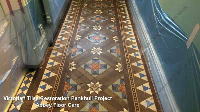Original patterned Victorian hallway tiles in Penkhull showing residue and muted color