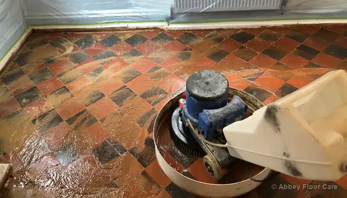 Professional floor restoration equipment removing deep contamination from a tiled surface